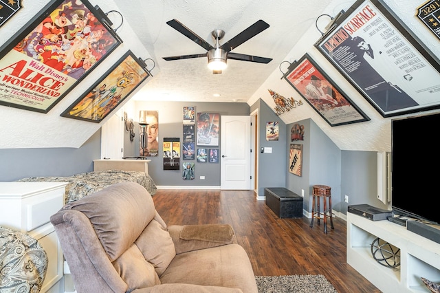 living room with ceiling fan, lofted ceiling, dark hardwood / wood-style flooring, and a textured ceiling