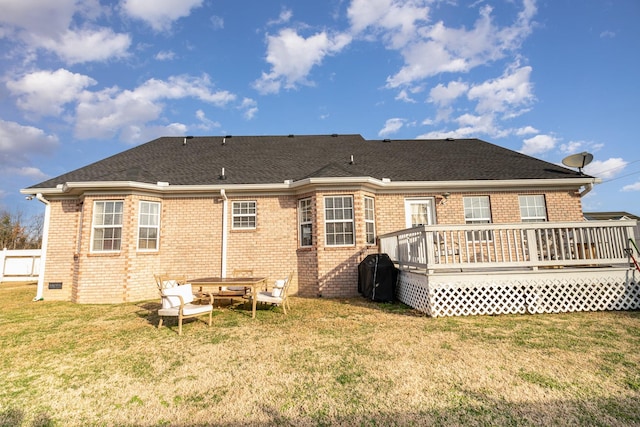 back of property with a wooden deck and a yard