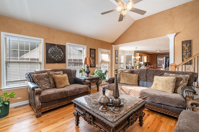 living room with decorative columns, lofted ceiling, ceiling fan, and light hardwood / wood-style flooring