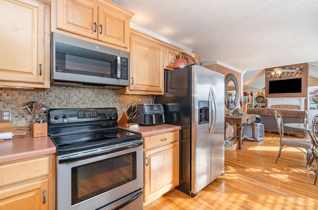 kitchen with crown molding, appliances with stainless steel finishes, tasteful backsplash, light hardwood / wood-style floors, and light brown cabinets