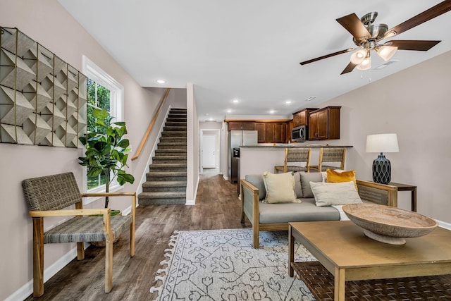 living room featuring dark hardwood / wood-style flooring and ceiling fan