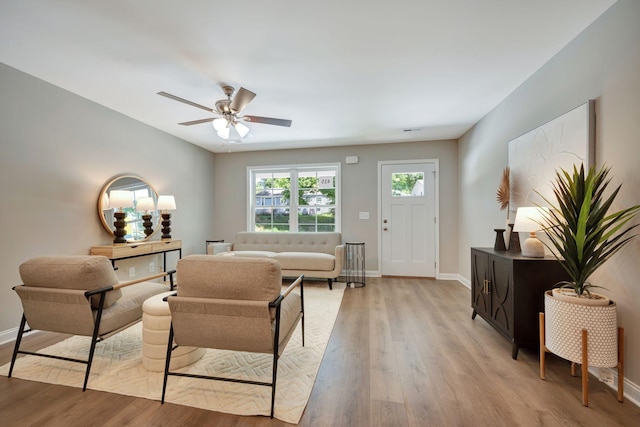 living room with ceiling fan and light wood-type flooring