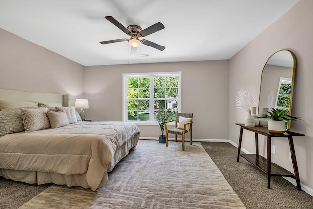 bedroom with ceiling fan and dark colored carpet