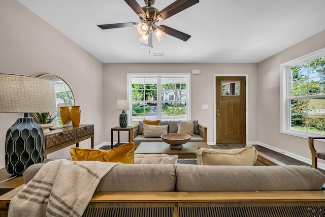 living room featuring hardwood / wood-style flooring, ceiling fan, and plenty of natural light