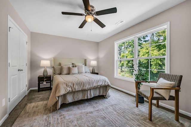 bedroom with dark colored carpet and ceiling fan