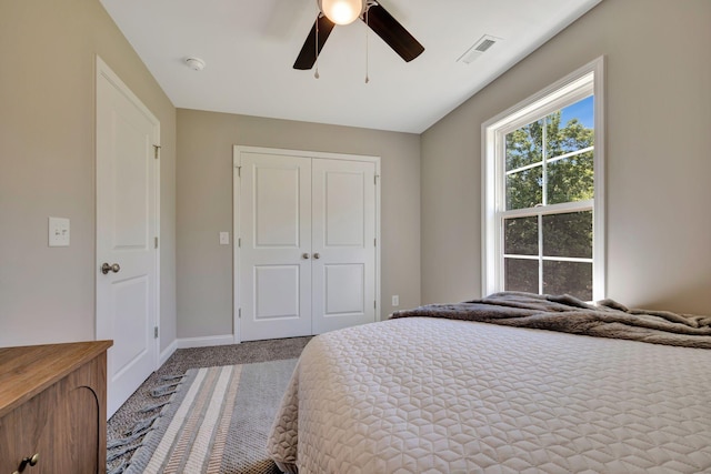 bedroom featuring ceiling fan, a closet, and light carpet