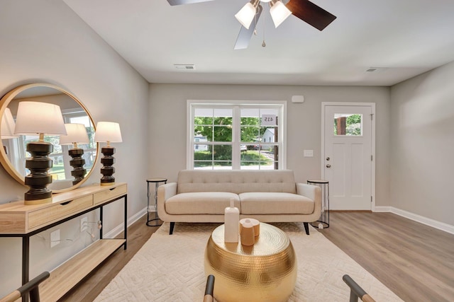 living room with hardwood / wood-style floors and ceiling fan