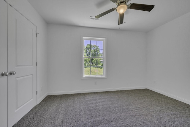 carpeted empty room featuring ceiling fan