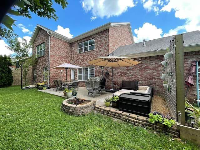 rear view of house with a patio, a yard, and an outdoor fire pit