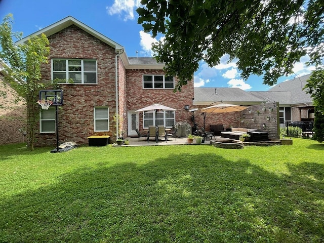 back of house featuring a patio and a yard