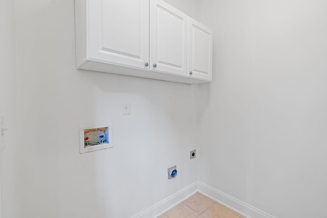 washroom with cabinets, light tile patterned flooring, washer hookup, and hookup for an electric dryer