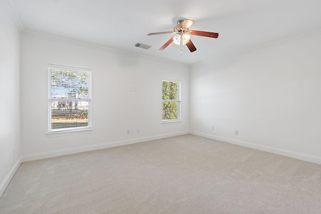 carpeted empty room with ceiling fan and ornamental molding