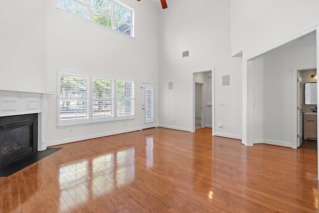 unfurnished living room featuring ceiling fan and light hardwood / wood-style flooring