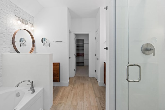 bathroom featuring separate shower and tub and hardwood / wood-style floors