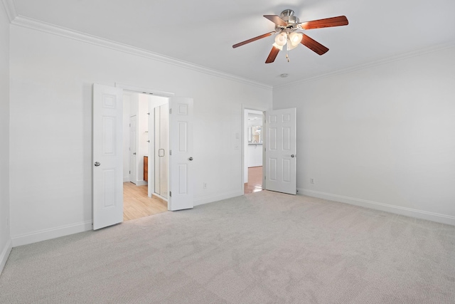 unfurnished bedroom featuring light carpet, crown molding, and ceiling fan