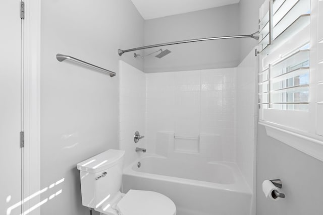 bathroom featuring washtub / shower combination and toilet