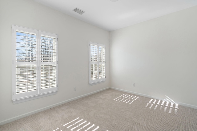 unfurnished room with light colored carpet