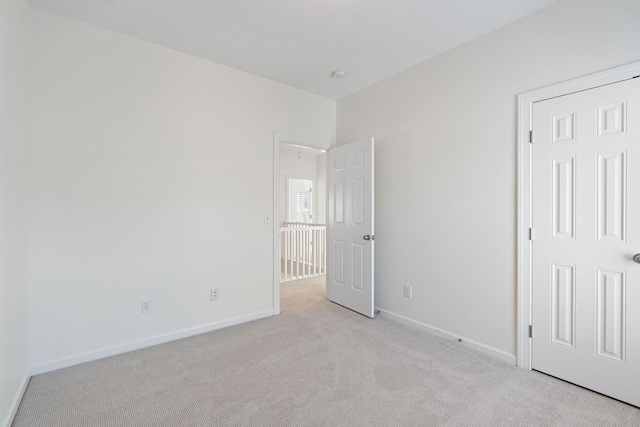 unfurnished bedroom with light colored carpet