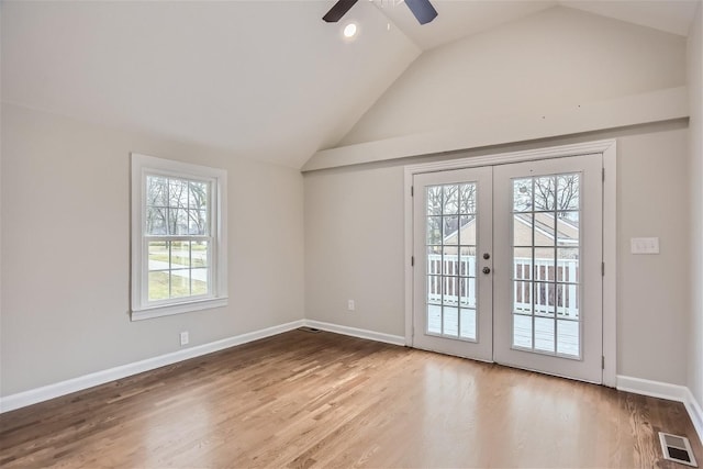 doorway featuring hardwood / wood-style flooring, vaulted ceiling, ceiling fan, and french doors