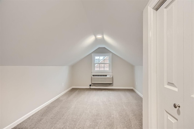 bonus room with vaulted ceiling and carpet floors