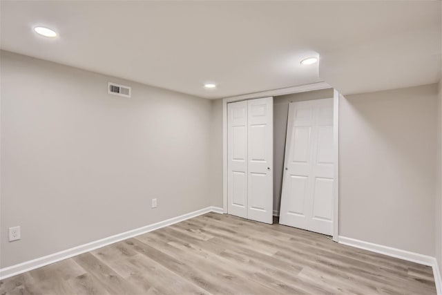 unfurnished bedroom featuring light hardwood / wood-style floors and a closet