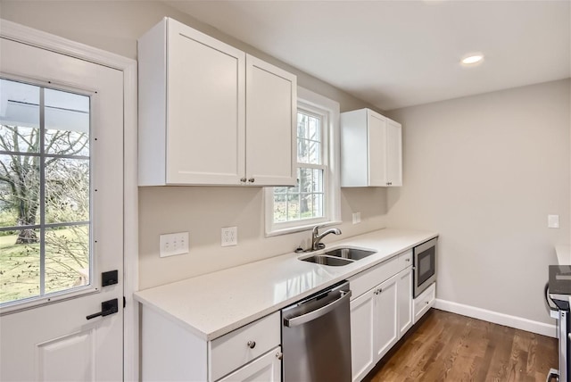 kitchen featuring sink, dark wood-type flooring, stainless steel appliances, and white cabinets