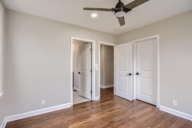 unfurnished bedroom with wood-type flooring, ceiling fan, and a closet