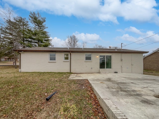 rear view of house with a yard and a patio area