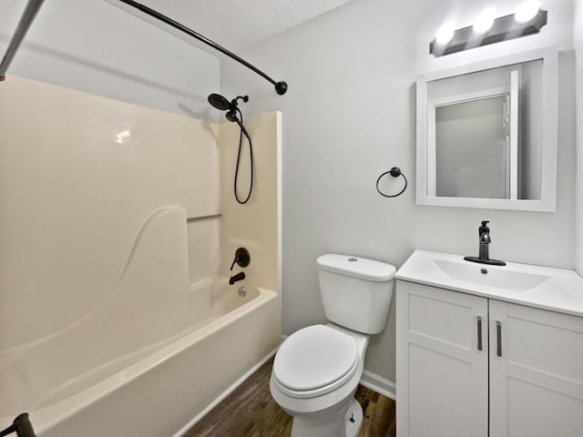 full bathroom with toilet, wood-type flooring, a textured ceiling, vanity, and shower / bath combination