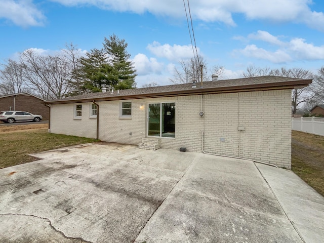 back of house featuring a yard and a patio area