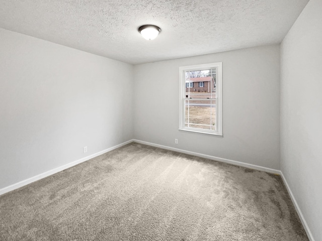 carpeted spare room featuring a textured ceiling