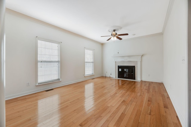 unfurnished living room with crown molding, light hardwood / wood-style flooring, and ceiling fan