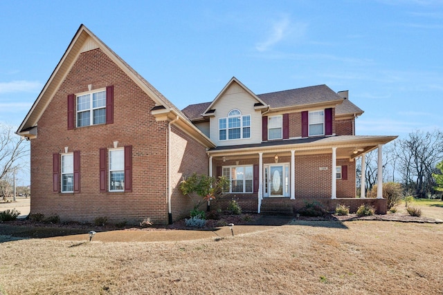 view of front facade with a front lawn and a porch