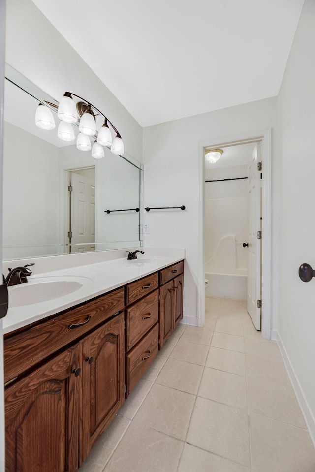 bathroom featuring vanity, bathtub / shower combination, and tile patterned flooring