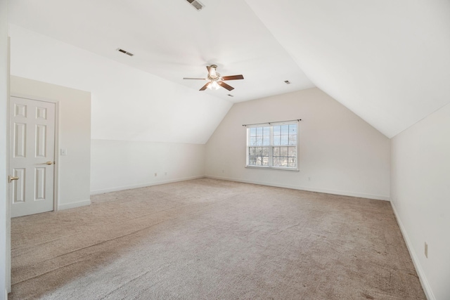 bonus room with vaulted ceiling, light colored carpet, and ceiling fan