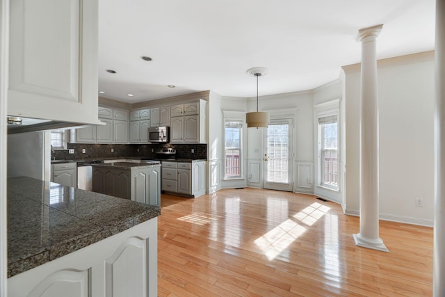 kitchen featuring gray cabinetry, pendant lighting, stainless steel appliances, and ornate columns