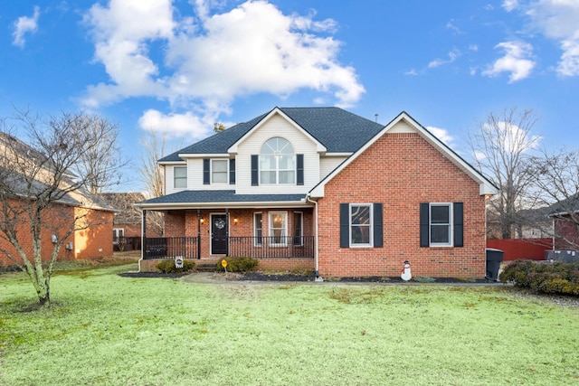 front of property featuring covered porch and a front lawn