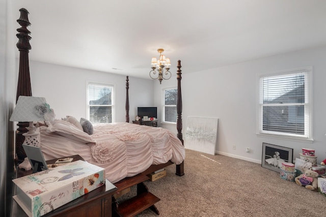 carpeted bedroom with a chandelier