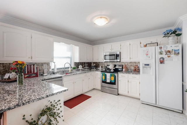 kitchen with appliances with stainless steel finishes, sink, and white cabinets