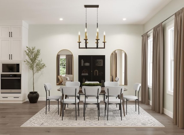 dining space featuring an inviting chandelier and hardwood / wood-style flooring