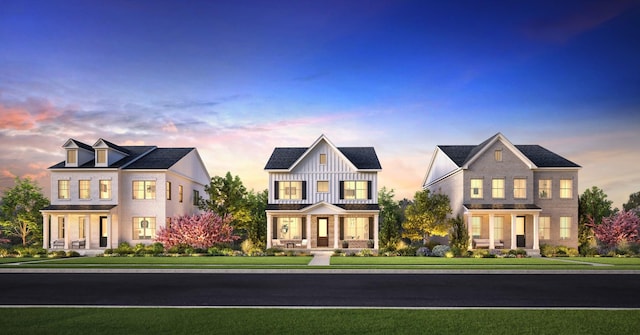 view of front facade featuring board and batten siding and a front lawn