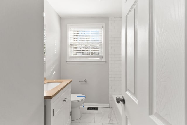 bathroom featuring vanity and toilet