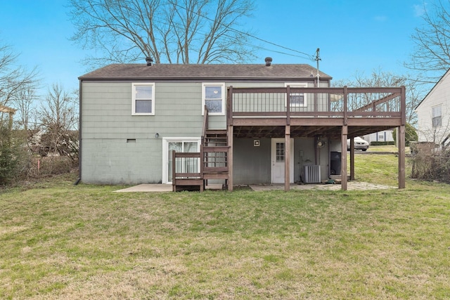 back of property featuring a wooden deck, a yard, a patio area, and central AC