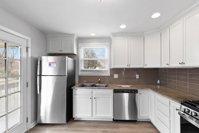 kitchen with white cabinetry, appliances with stainless steel finishes, sink, and a wealth of natural light