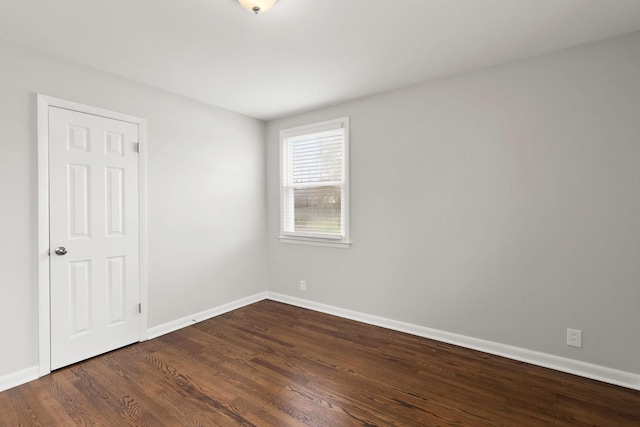 empty room with dark wood-type flooring