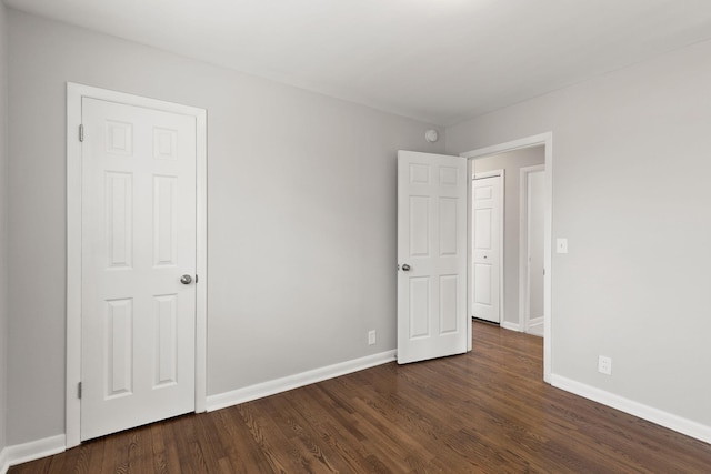 unfurnished bedroom with dark hardwood / wood-style floors