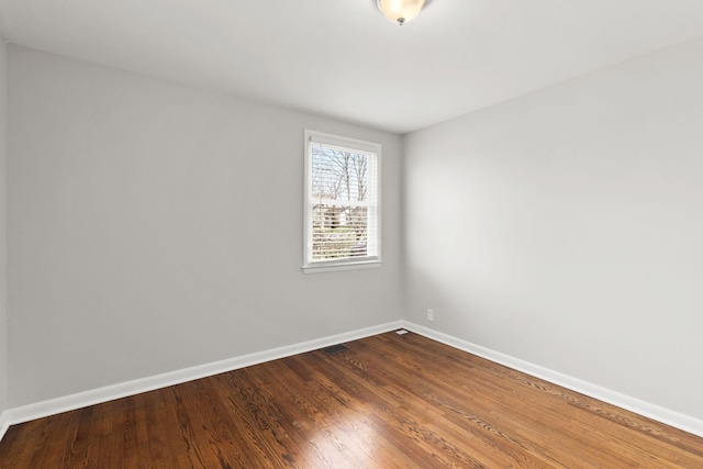 unfurnished room featuring hardwood / wood-style flooring