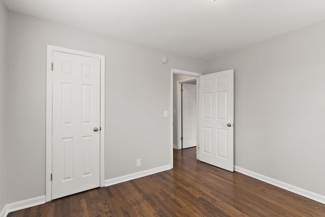 unfurnished bedroom featuring dark hardwood / wood-style flooring