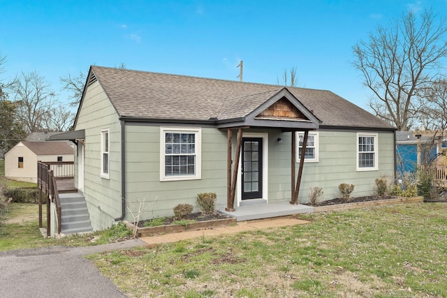 bungalow-style home with a front lawn