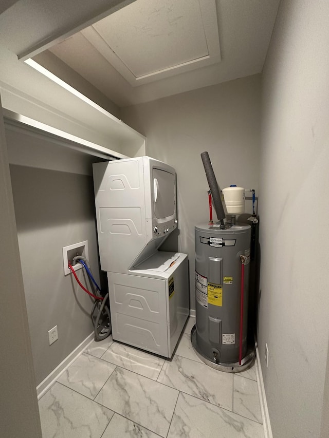 utilities with water heater and stacked washing maching and dryer